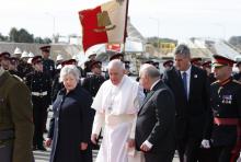 Pope Francis walks with Maltese President George Vella and his wife, Miriam, as he arrives at the international airport in Malta April 2, 2022. The pope was beginning a two-day trip to the Mediterranean archipelago. (CNS/Paul Haring)