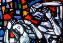 Adam and Eve are depicted in a stained-glass window at St. Nicolas Church in Feldkirch, Austria, in a 2004 file photo. (CNS photo from Crosiers)