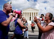 An abortion opponent and a supporter of legal abortion square off with megaphones in front of the U.S. Supreme Court in Washington June 24, 2023, the first anniversary the court's 2022 ruling in Dobbs v. Jackson Women