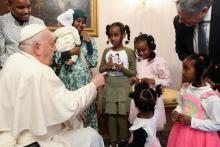 Pope Francis greets a Muslim family from Djibouti at the nunciature in Brussels Sept. 28. As refugees, they had reached Belgium thanks to the help of the Rome-based Community of Sant'Egidio. The visit came during the second full day of the pope's Sept. 27-29 visit to Belgium.  (CNS/Vatican Media)