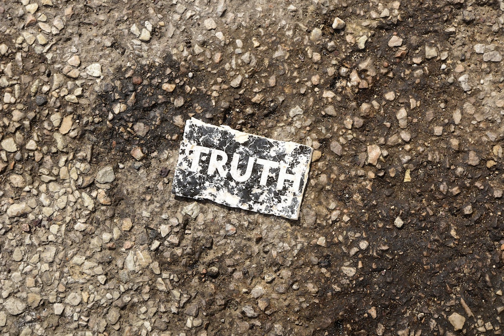 card with word "truth" on it on the ground