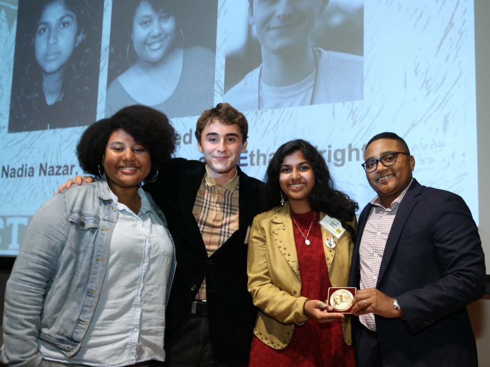 From left, Elsa Mengistu, Ethan Wright and Nadia Nazar from Zero Hour with event emcee Erica Smiley, after the group received its Letelier-Moffitt Human Rights Award (Institute for Policy Studies/Rick Reinhard)